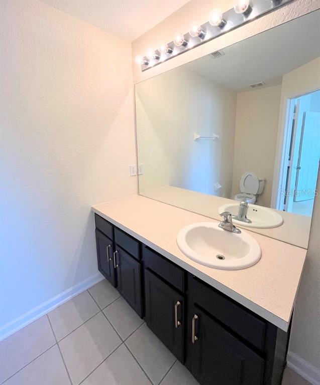 2534 Maneshaw Lane Kissimmee, FL 34747 - Photo 19 of 40 a bathroom with a sink and a mirror