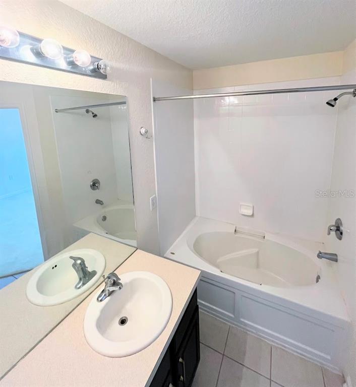 2534 Maneshaw Lane Kissimmee, FL 34747 - Photo 20 of 40 a bathroom with a sink and a tub