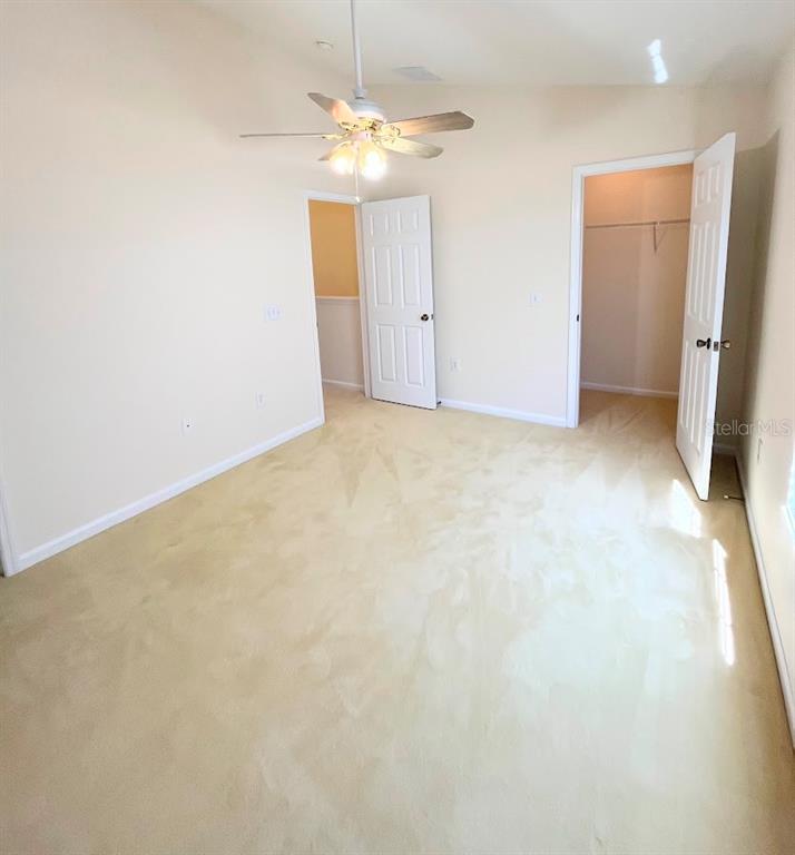2534 Maneshaw Lane Kissimmee, FL 34747 - Photo 26 of 40 an empty room with chandelier fan