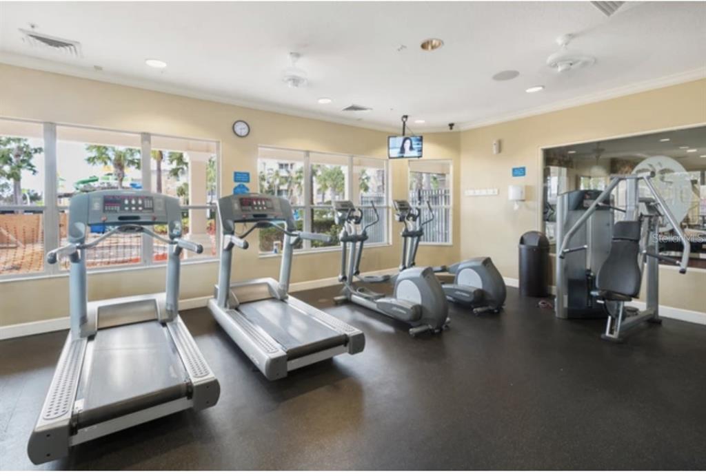 2534 Maneshaw Lane Kissimmee, FL 34747 - Photo 39 of 40 a room with gym equipment and a table