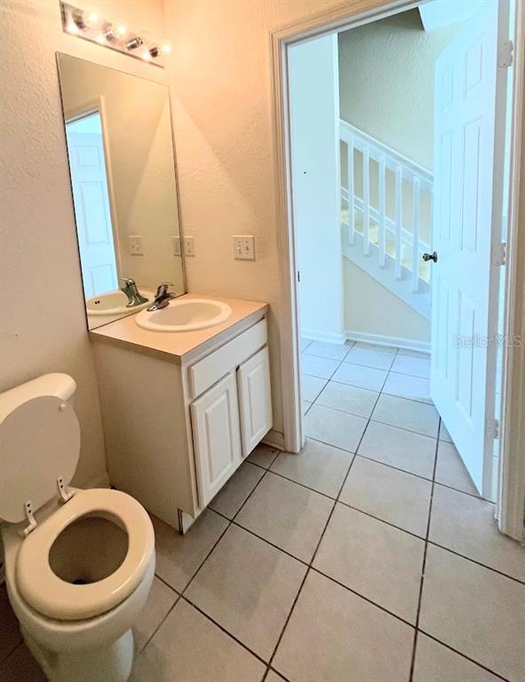2534 Maneshaw Lane Kissimmee, FL 34747 - Photo 10 of 40 a bathroom with a sink a toilet and a mirror
