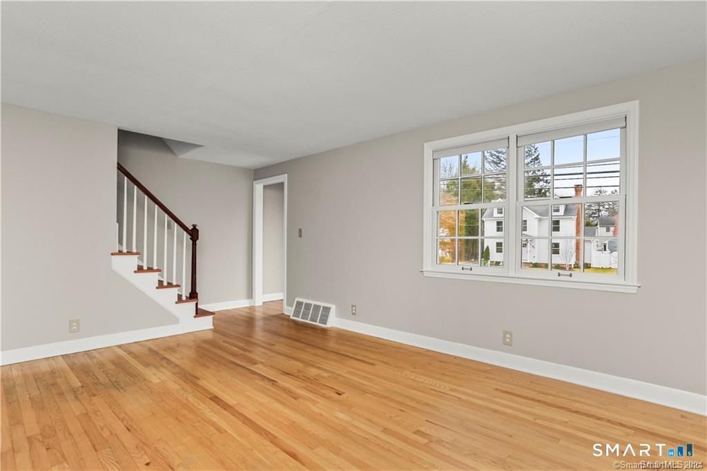608 Stillson Road Fairfield, CT 06824 - Photo 2 of 16 a view of an empty room with wooden floor and a window
