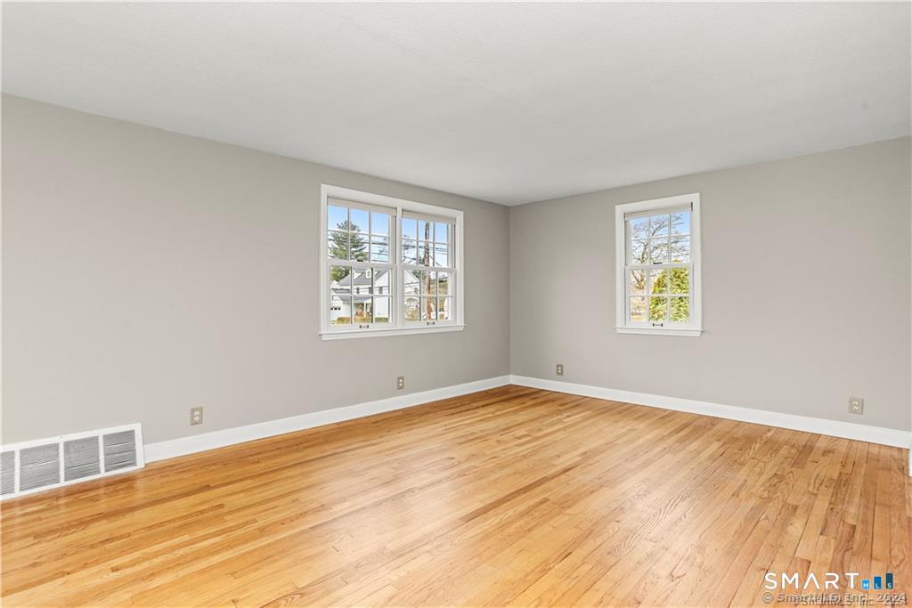608 Stillson Road Fairfield, CT 06824 - Photo 3 of 16 a view of an empty room with wooden floor and a window