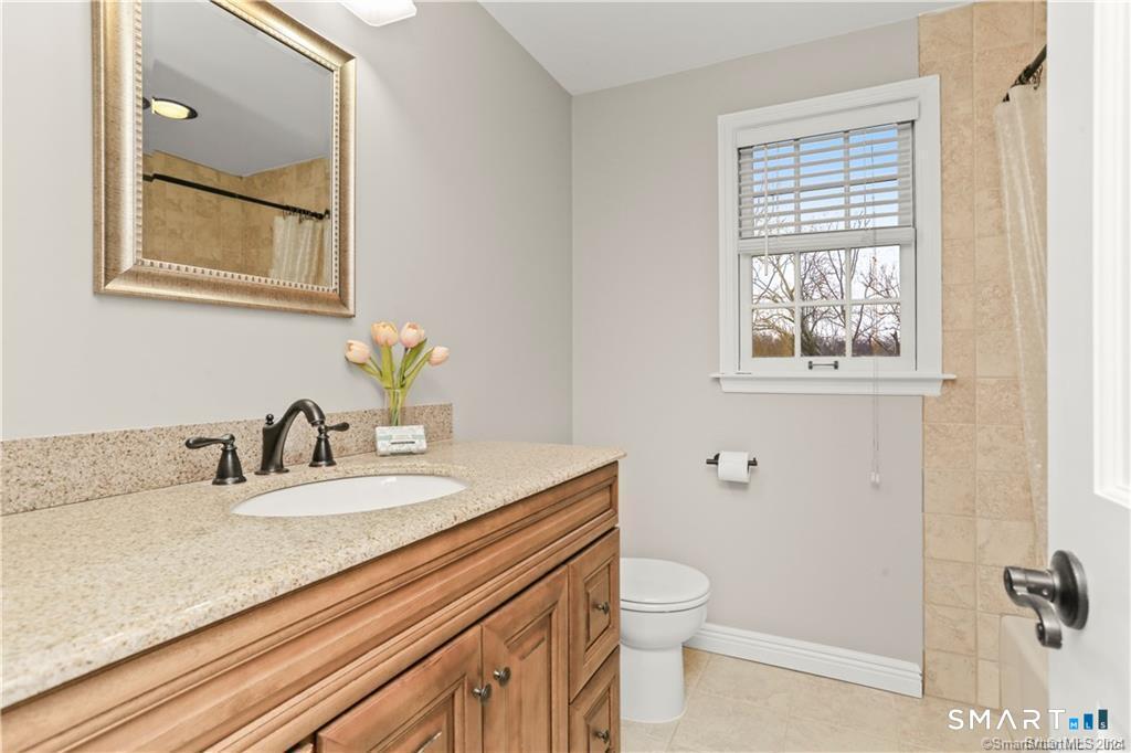 608 Stillson Road Fairfield, CT 06824 - Photo 9 of 16 a bathroom with a granite countertop sink toilet and shower