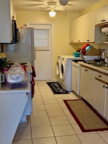 a kitchen with a sink a stove and cabinets