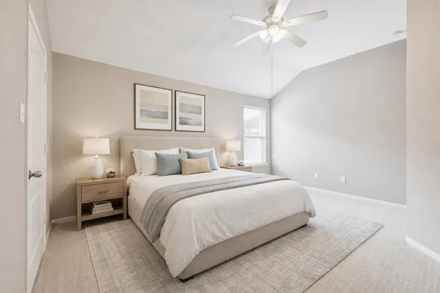 a bedroom with a bed and a ceiling fan
