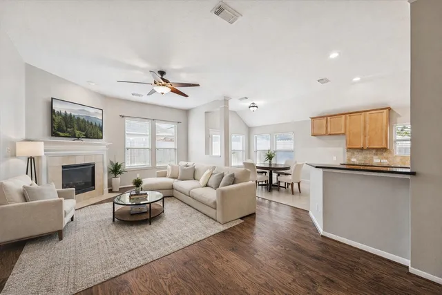 a living room with furniture a fireplace and a flat screen tv