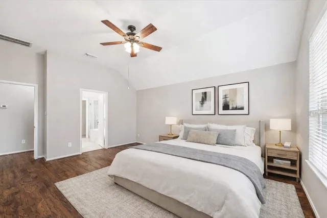 a bedroom with a large bed and a chandelier