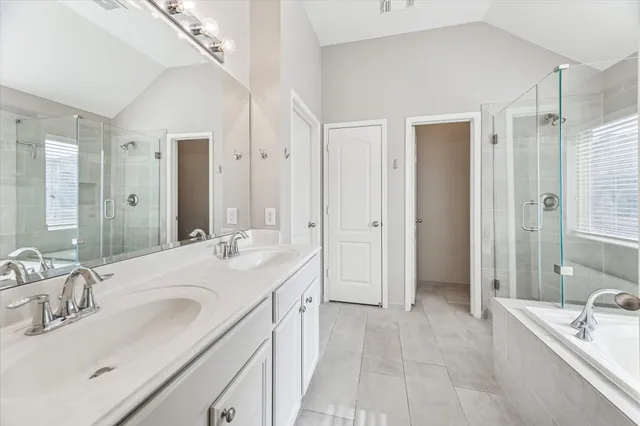 a spacious bathroom with a bathtub shower sink double and mirror