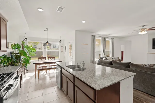 a kitchen with counter space dining table and chairs