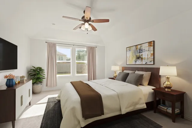 a bedroom with a large bed and a flat screen tv