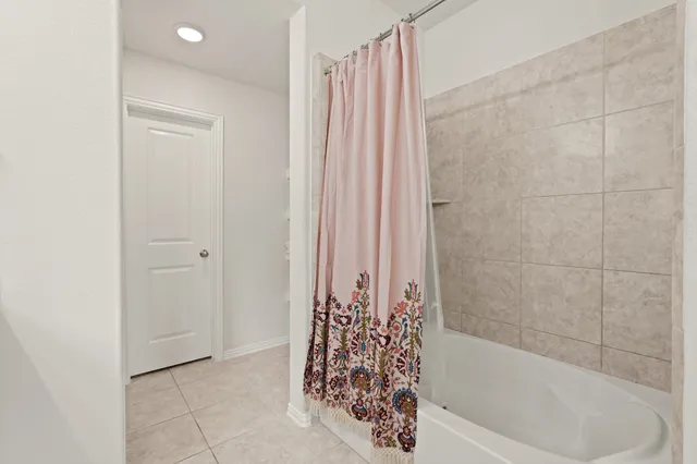 a bathroom with a bathtub and shower