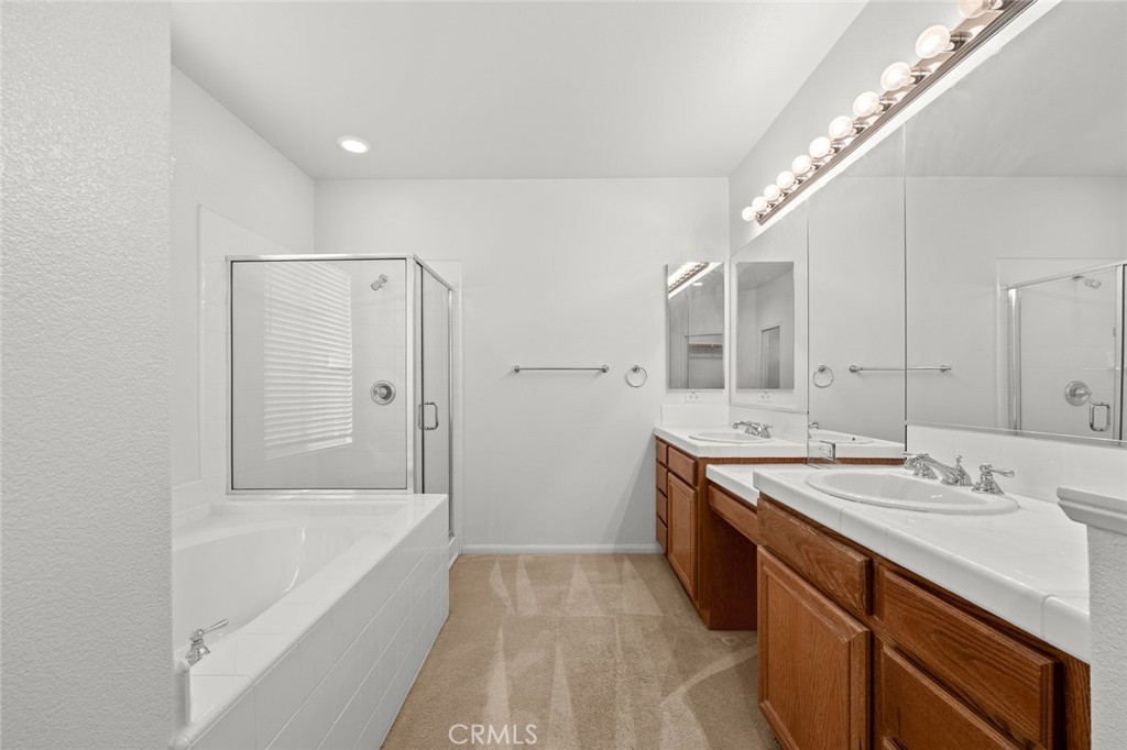 44855 Rutherford Street Temecula, CA 92592 - Photo 20 of 31 a spacious bathroom with a tub sink and mirror