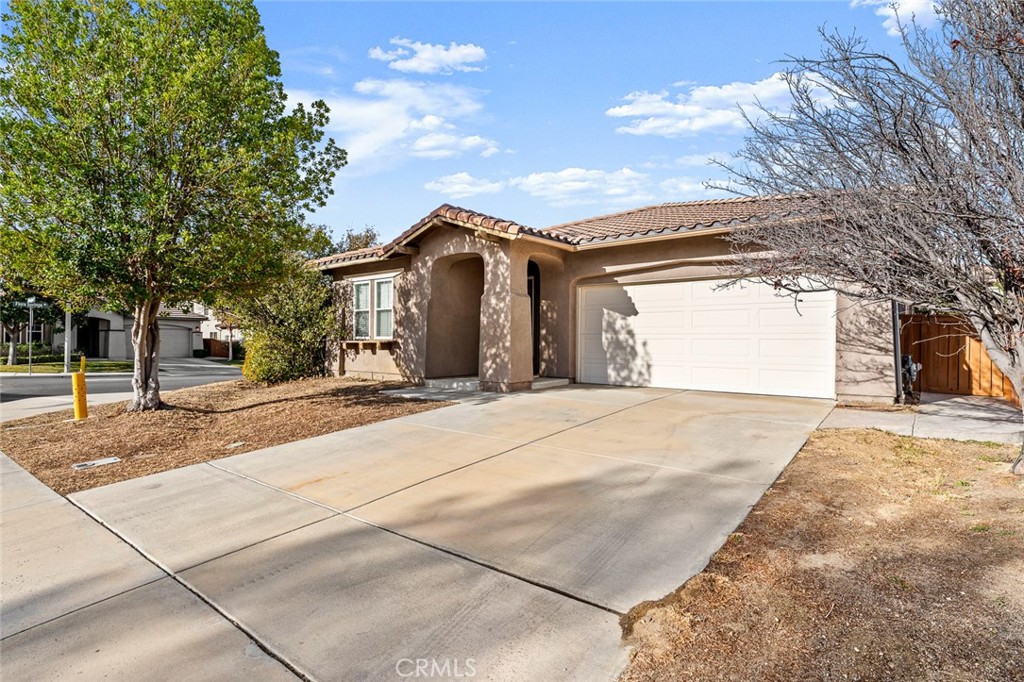 44855 Rutherford Street Temecula, CA 92592 - Photo 26 of 31 a front view of a house with a yard and garage