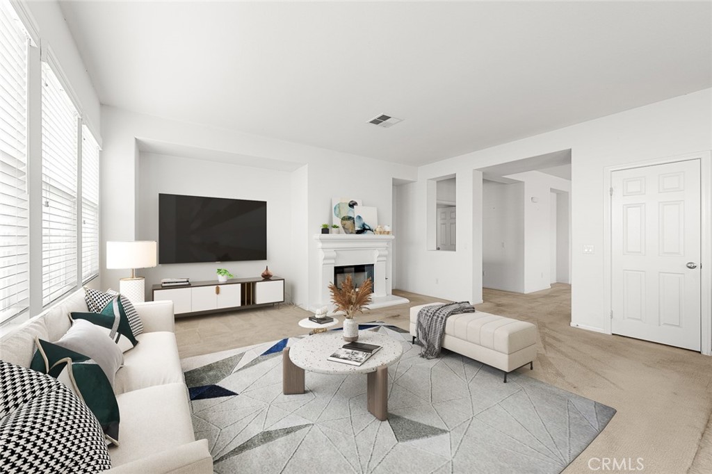 44855 Rutherford Street Temecula, CA 92592 - Photo 3 of 31 a living room with furniture a fireplace and a flat screen tv