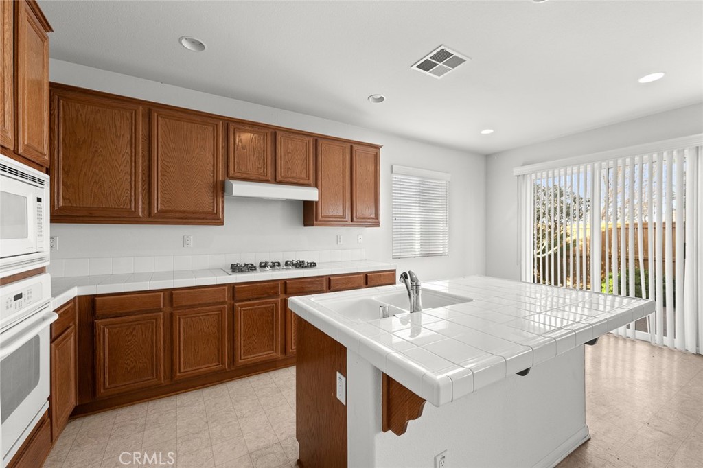 44855 Rutherford Street Temecula, CA 92592 - Photo 6 of 31 a kitchen that has a sink and a stove in it