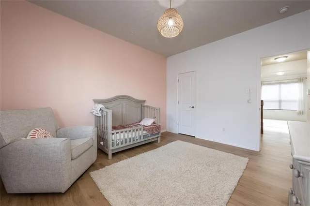 a bedroom with furniture and wooden floor
