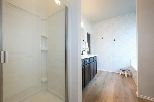 a bedroom with a large bed chandelier and a window