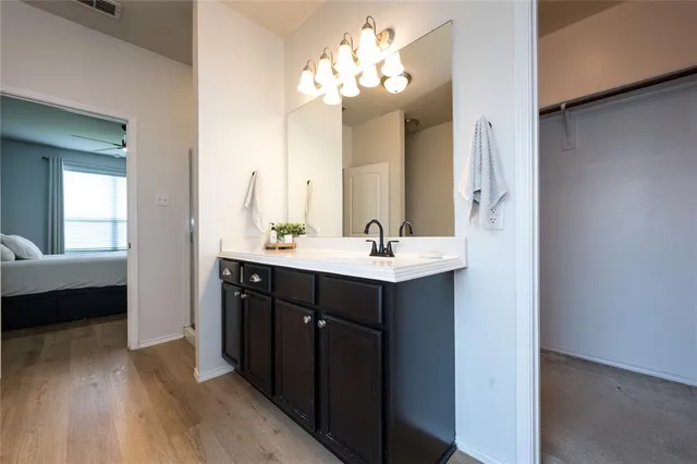 a bathroom with a double vanity sink and a mirror