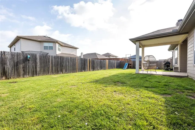 a view of a house with backyard and porch