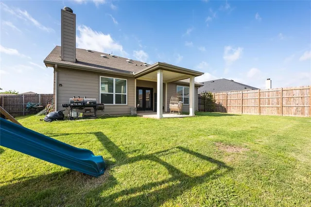 a view of a house with pool and chairs