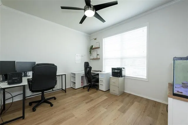 a view of a workspace with furniture and a window