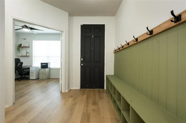 a view of a hallway view with wooden floor and staircase