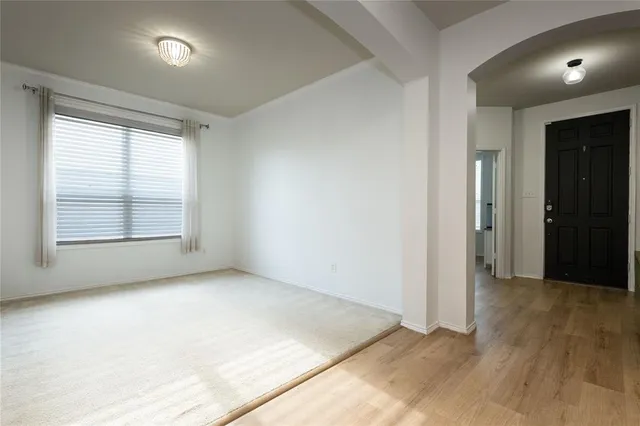 an empty room with windows and closet