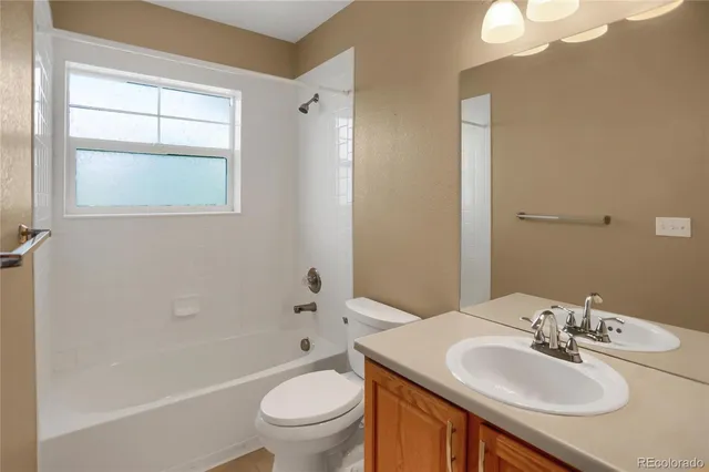 a bathroom with a sink toilet vanity and tub