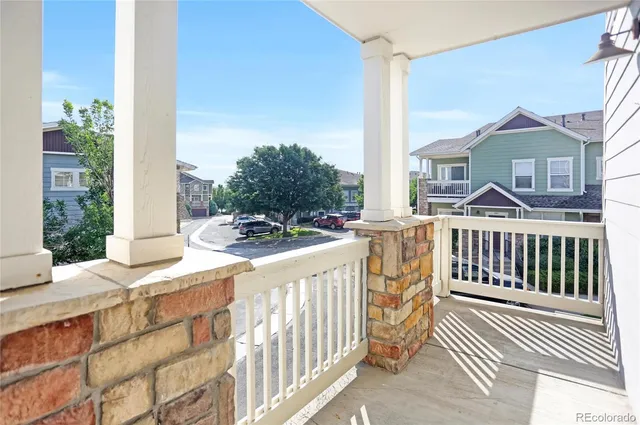 a view of a house with a small yard and wooden fence