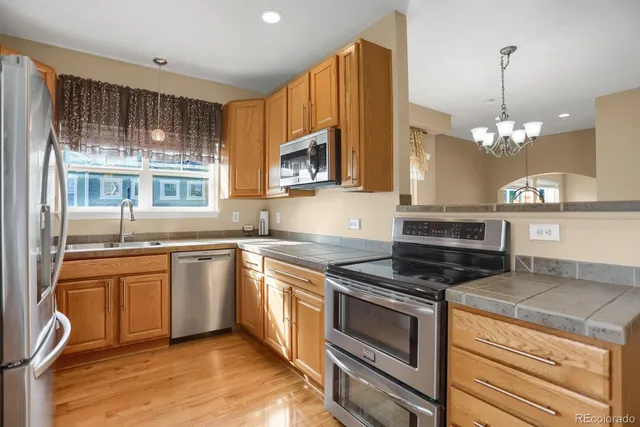 a kitchen with stainless steel appliances granite countertop a stove and cabinets