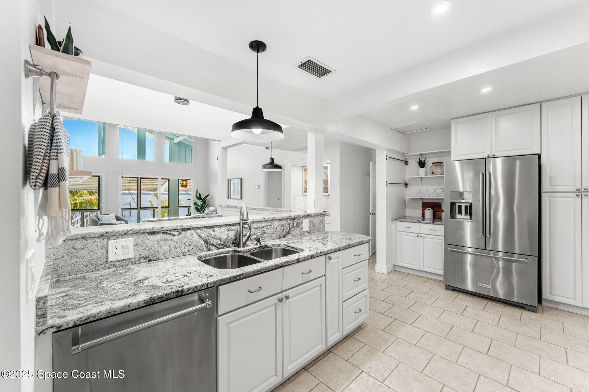 2016 Indian River Drive Cocoa, FL 32922 - Photo 14 of 49 a kitchen with stainless steel appliances granite countertop a sink and a refrigerator