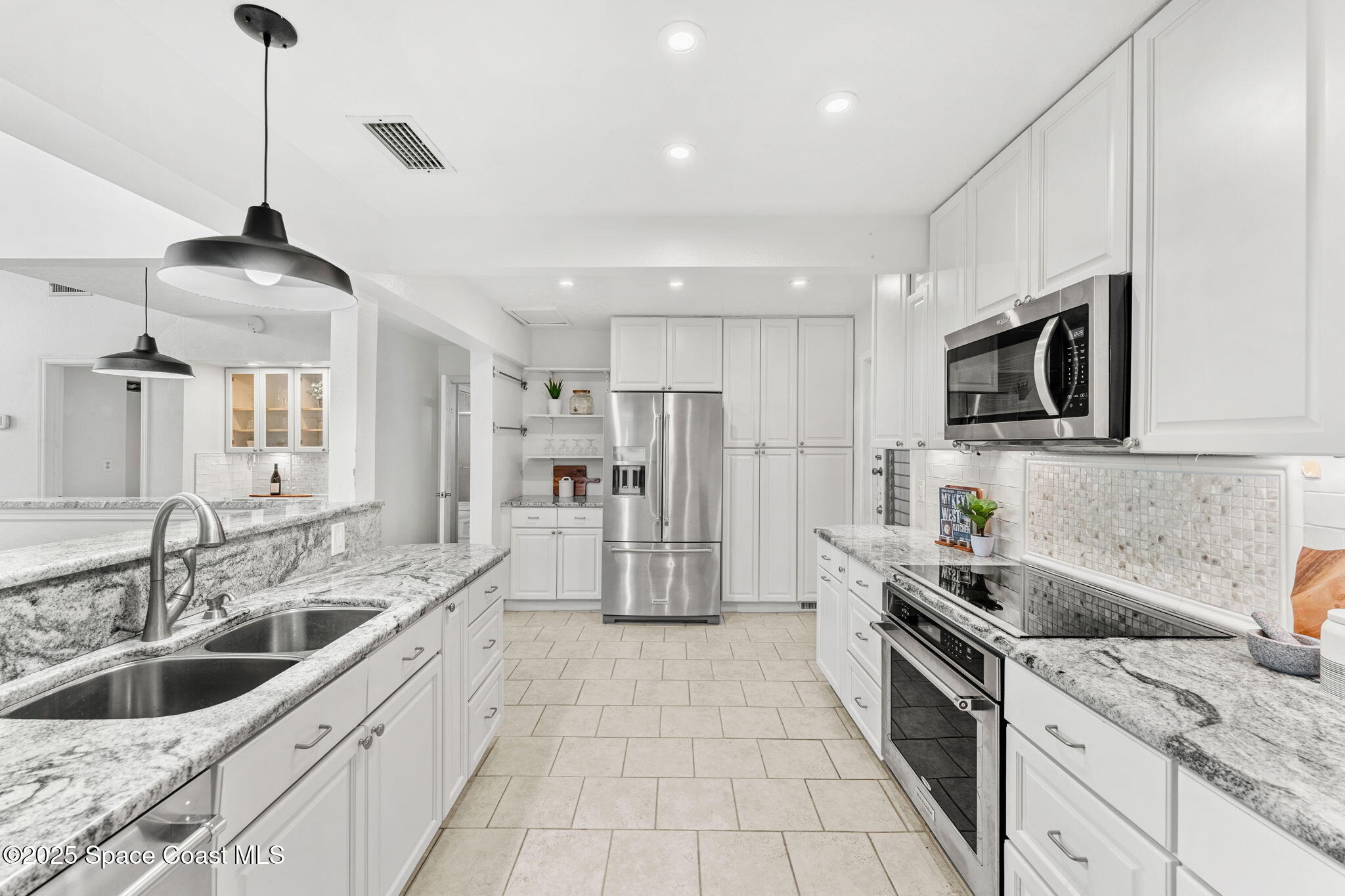 2016 Indian River Drive Cocoa, FL 32922 - Photo 15 of 49 a kitchen with stainless steel appliances granite countertop a sink and a refrigerator