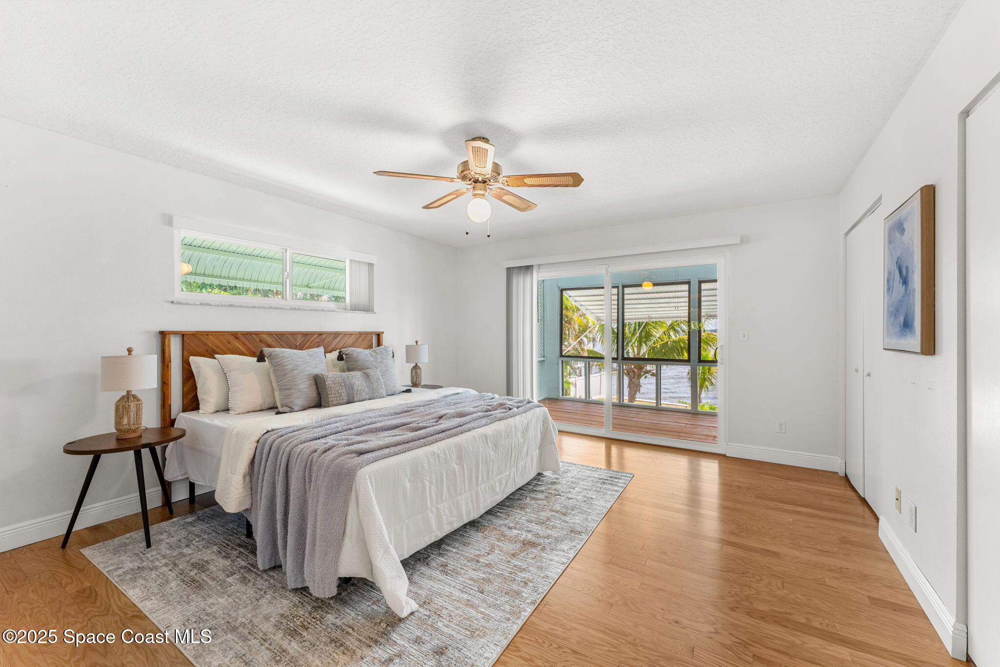 2016 Indian River Drive Cocoa, FL 32922 - Photo 20 of 49 a bedroom with a large bed and a chandelier