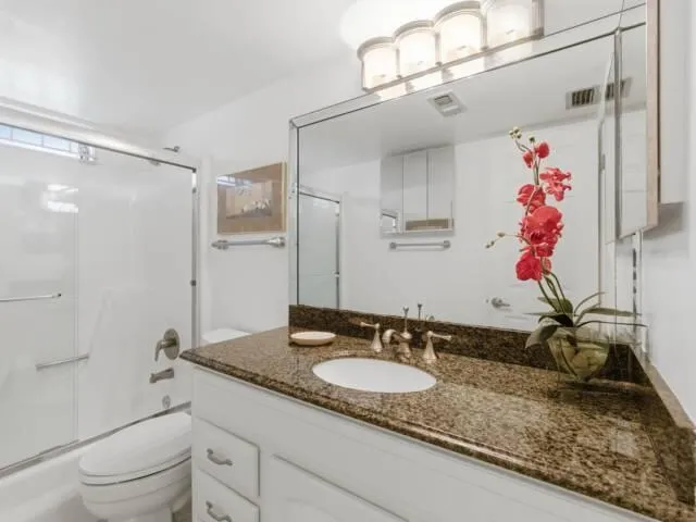 a bedroom with a bed and a table with lamp