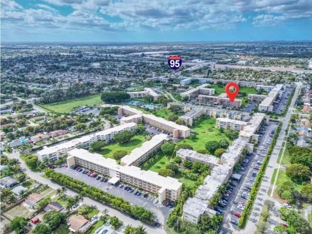 a bathroom with a granite countertop sink toilet a mirror and shower