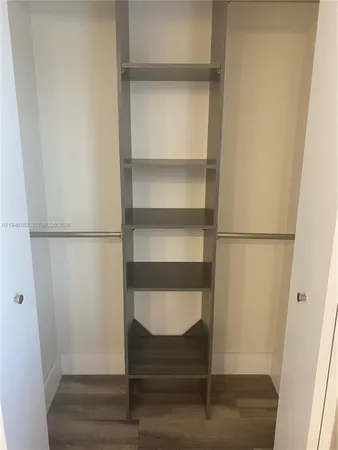 a view of walk in closet with empty racks