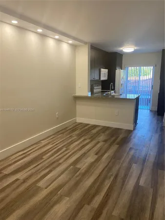 a view of kitchen with cabinets and wooden floor