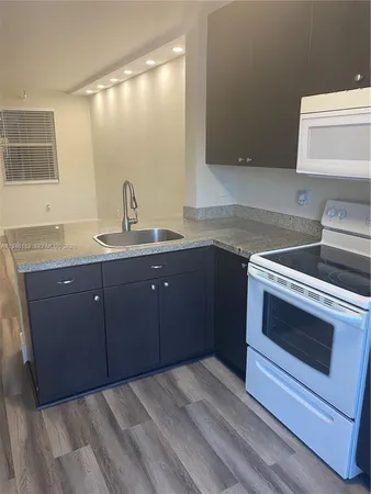 a kitchen with a sink and a stove