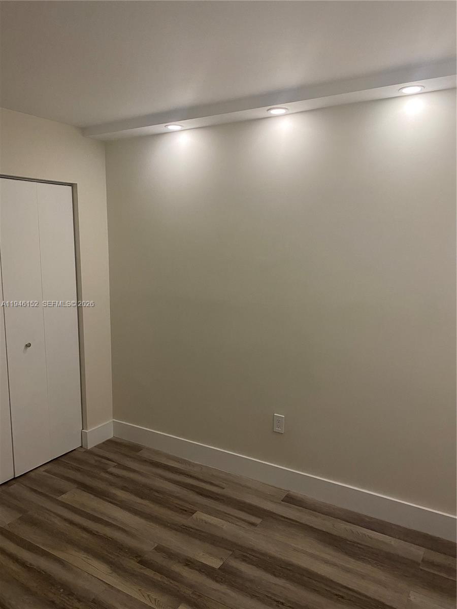 2575 Southwest 27th Avenue, Unit 212 Coconut Grove, FL 33133 - Photo 7 of 12 a view of room with window and wooden floor