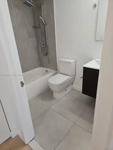 a bathroom with a toilet and a bath tub