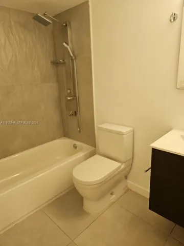 a bathroom with a toilet and a bath tub