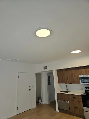 a kitchen with a refrigerator and a sink