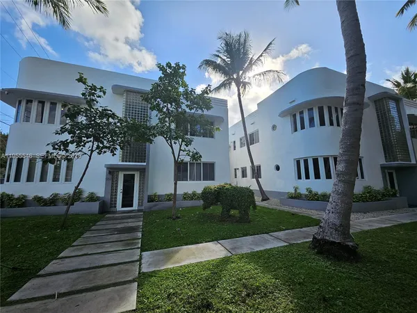 a front view of a house with a garden and yard