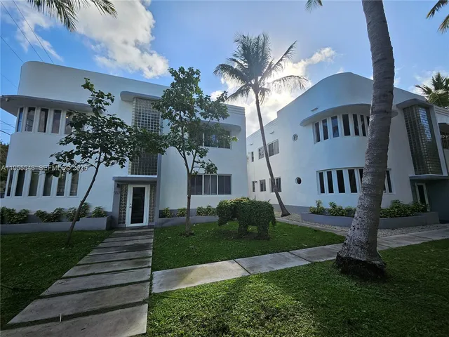 a front view of a house with a garden and yard