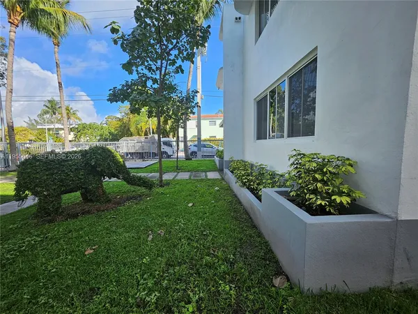 a view of a house with a backyard and a garden