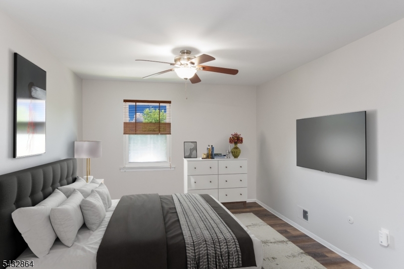 504 Nottingham Way, Unit 504 Flemington, NJ 08822 - Photo 2 of 12 a bedroom with a bed and a flat screen tv
