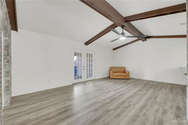 a view of a livingroom with wooden floor and a ceiling fan