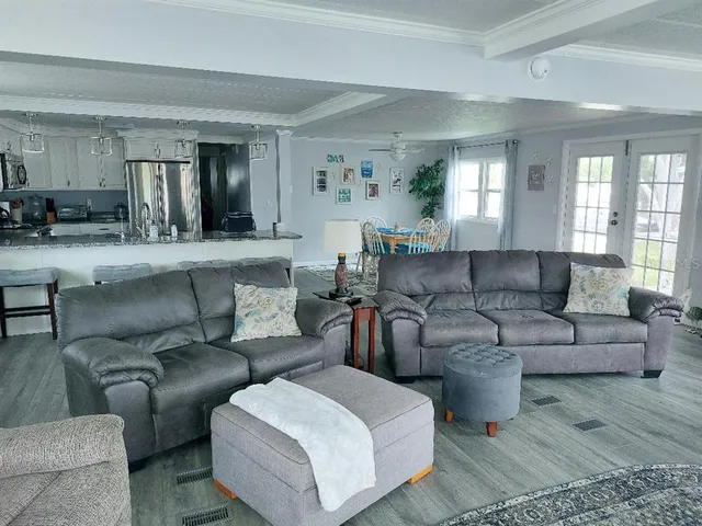 a kitchen with stainless steel appliances granite countertop a sink stove and wooden floor