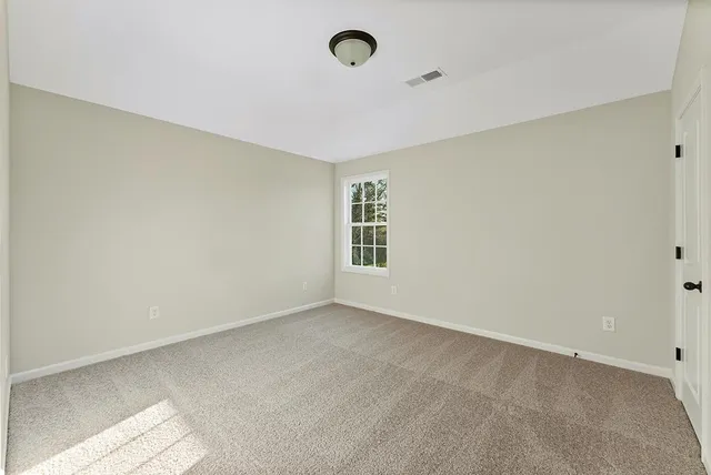 a view of an empty room with windows
